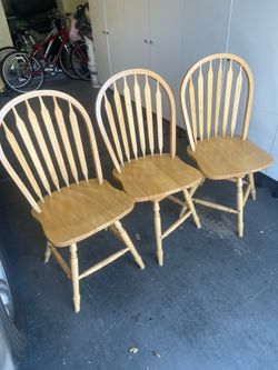 3 Solid wood swivel chairs in excellent condition.