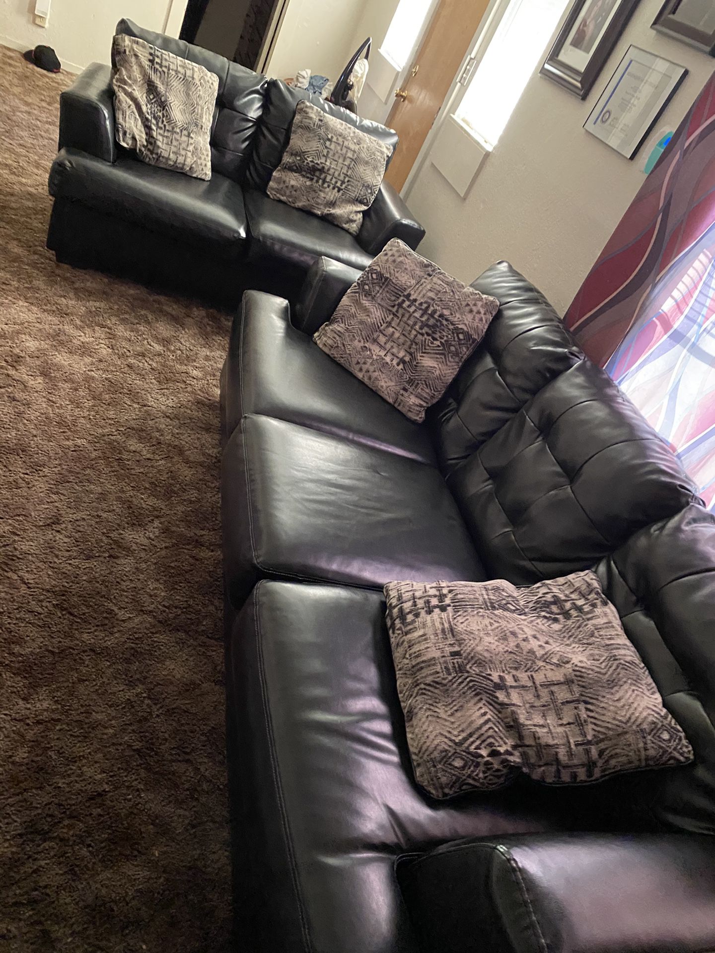 Black leather sofa and love seat with pollows included