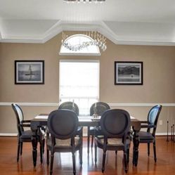 Modern baroque black lacquer dining-room table with crocodile pattern chairs