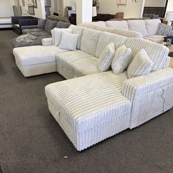 Sectional sleeper with storage arms and wireless chargers