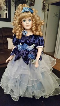 Porcelain doll in 2 tone blue dress