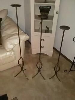 Set of three metal floor candle holders