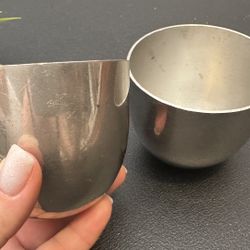Set of two silver coated metal cups.