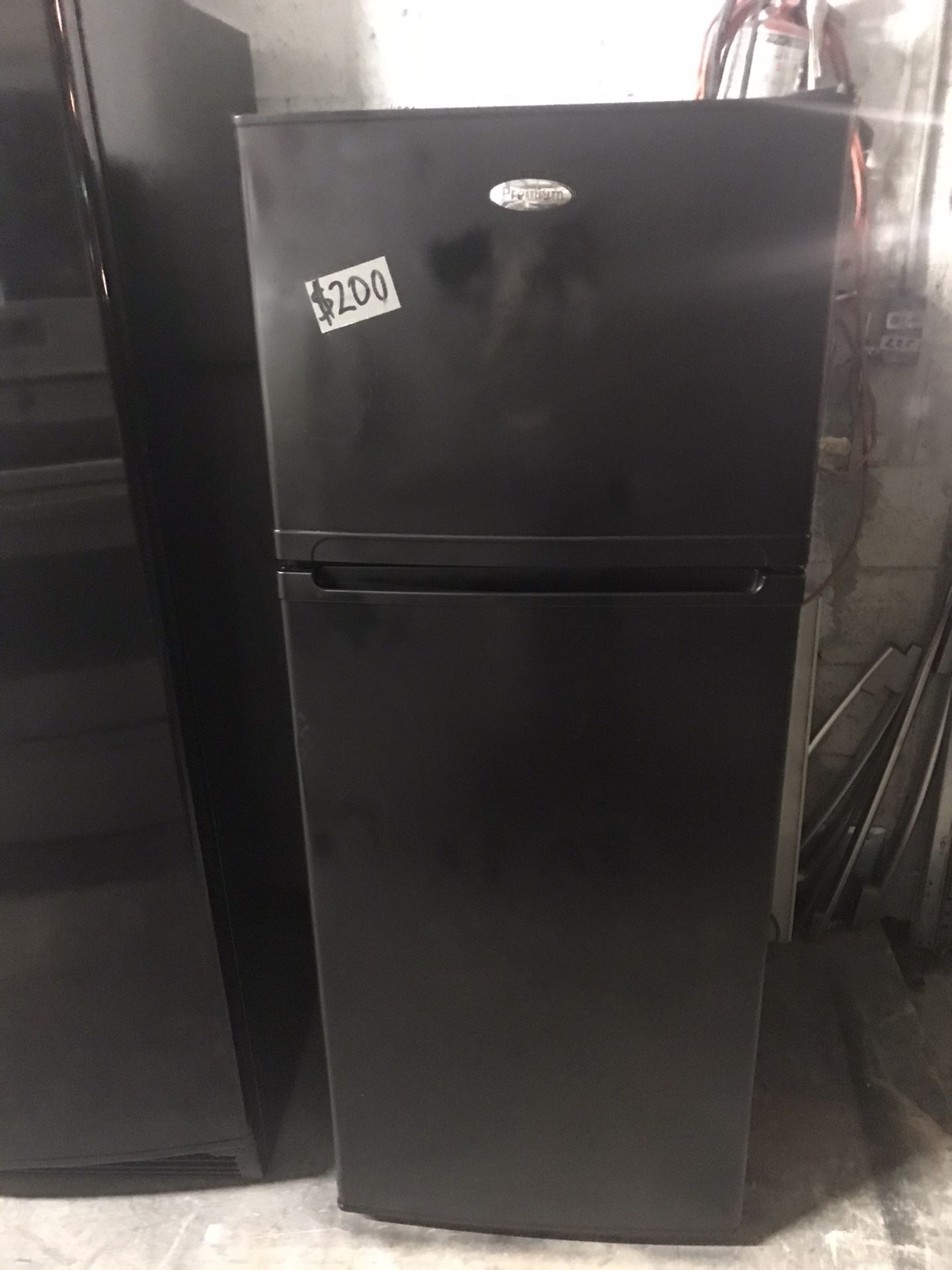 Premium black refrigerator 23” Wide 60” Tall in excellent condition condition plus 6 months warranty. Delivery service available. Hablamos español