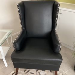 Black Faux Leather Wing Back Chair.   Perfect Condition.  28” Wide X 43” Tall X 30” Deep.   