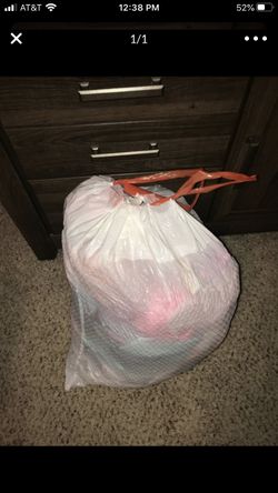 trash bag full of girl baby clothes