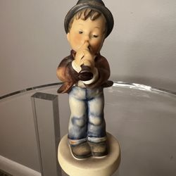 Goebel Hummel vintage figurine called "Serenade " #85/0, featuring a boy playing a horn