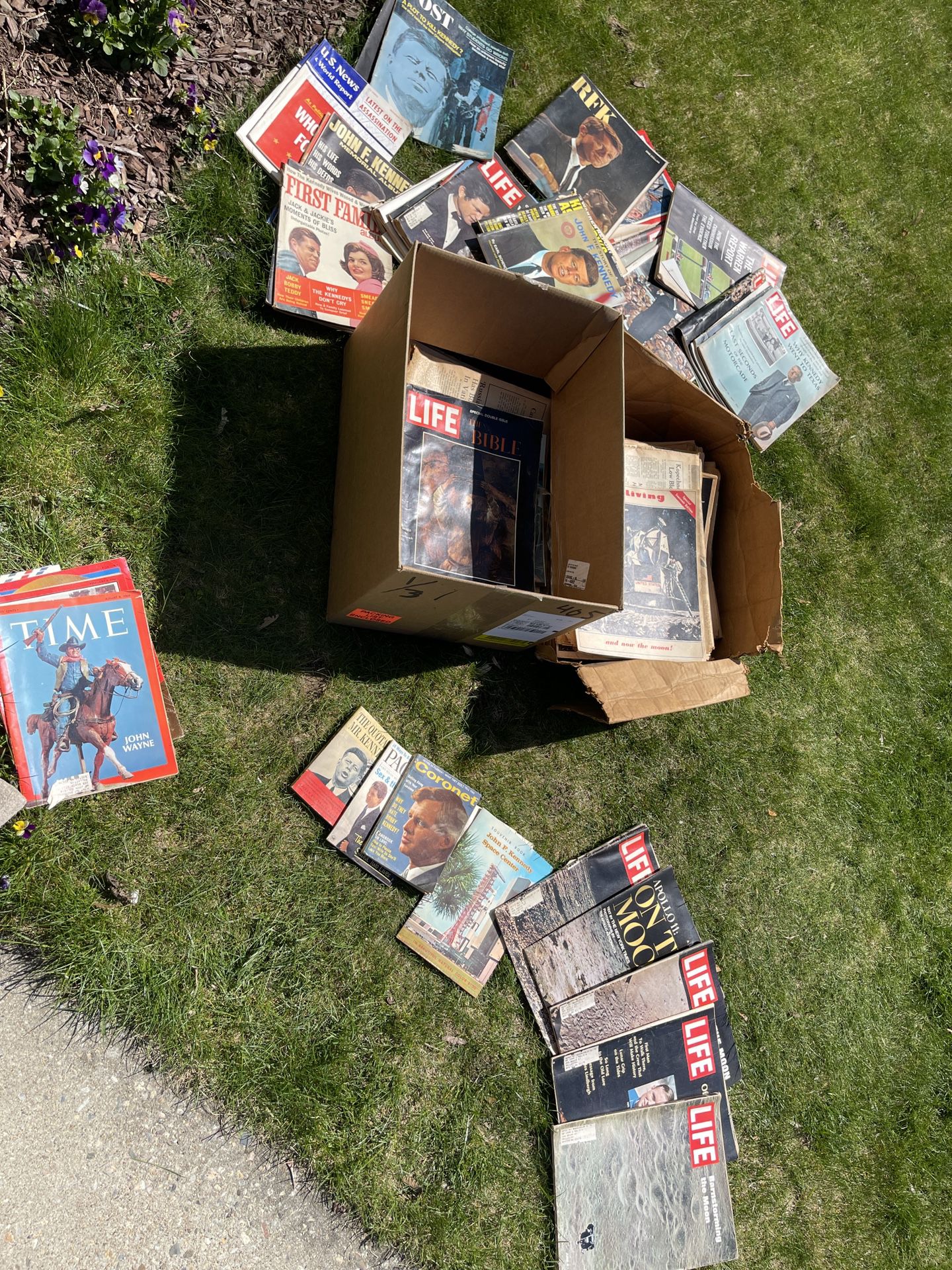 boxes of JFK and Moon landing magazine and newspapaer. 