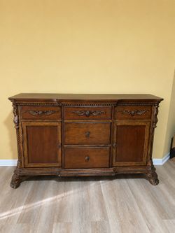 Solid wood dresser with carved details and ornate hardware