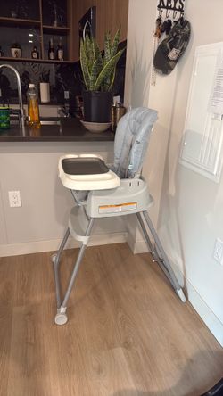 Baby blue and grey high chair for eating