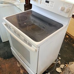 White electric stove with glass cooktop, fully working and ready to use.