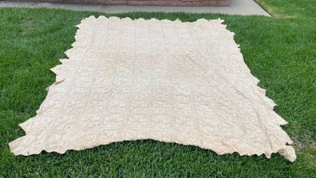 A  king size beige Afghan