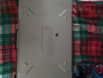 Coleman grill with burner. Needs cleaning but works. Uses small or large propane
