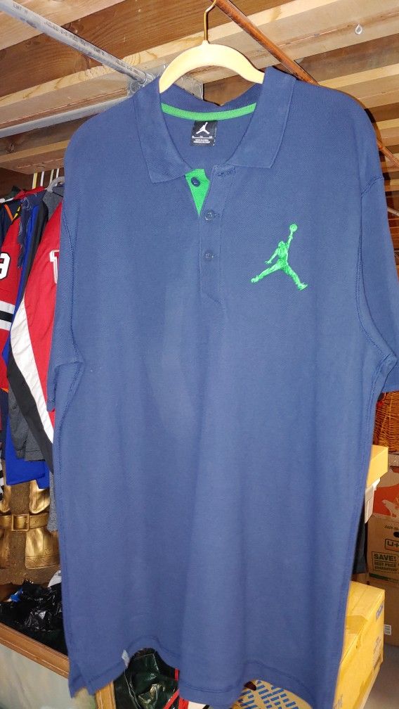 Blue Shirt With A Cream Trim And Jordan Logo