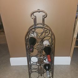 WINE RACK. 11 BOTTLE CAPACITY.  30 INCHES TALL BY 10 INCHES WIDE