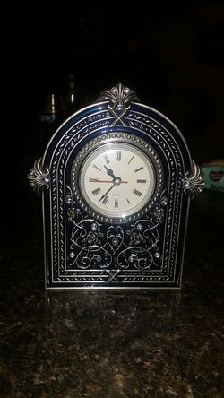 Decorative clock. Forestry design old world style. Color is a very dark blue with steel.