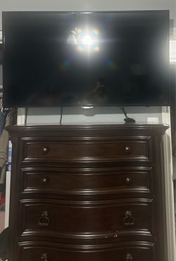 Dark wood 5- drawer chest & 60” Tv