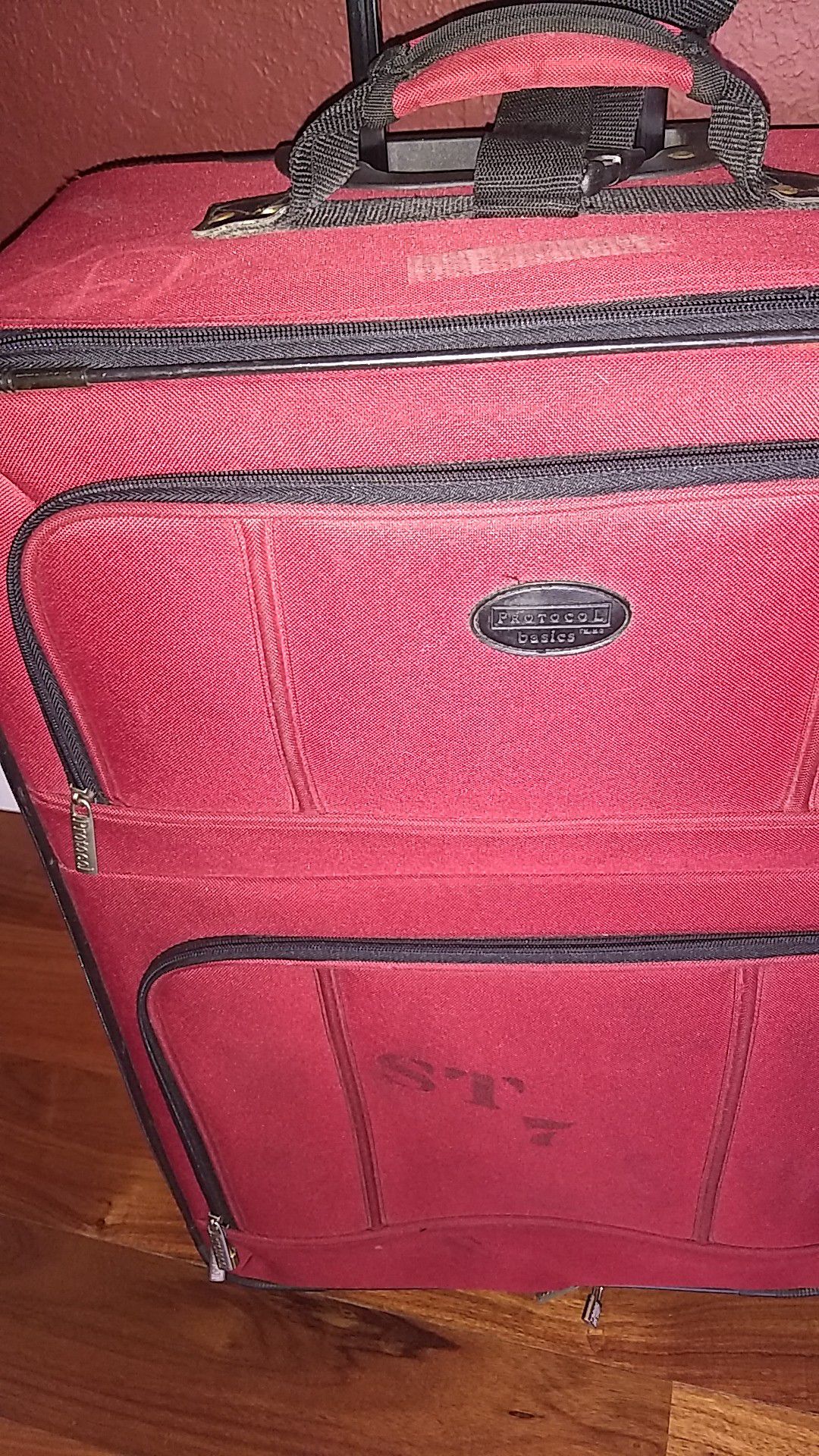 Red, rolling suitcase