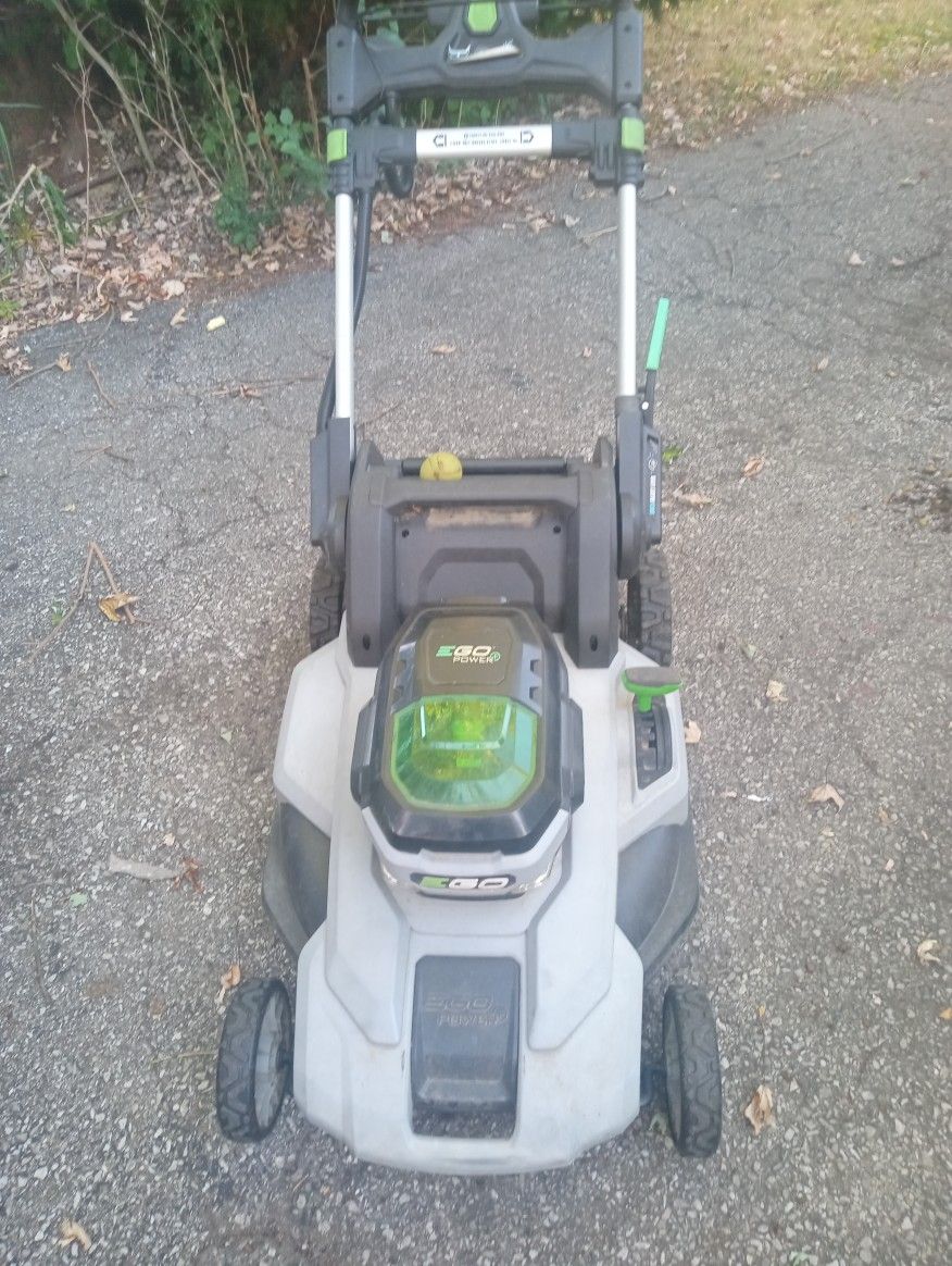 Ego Electric Lawn Mower, Battery Charger And Chainsaw