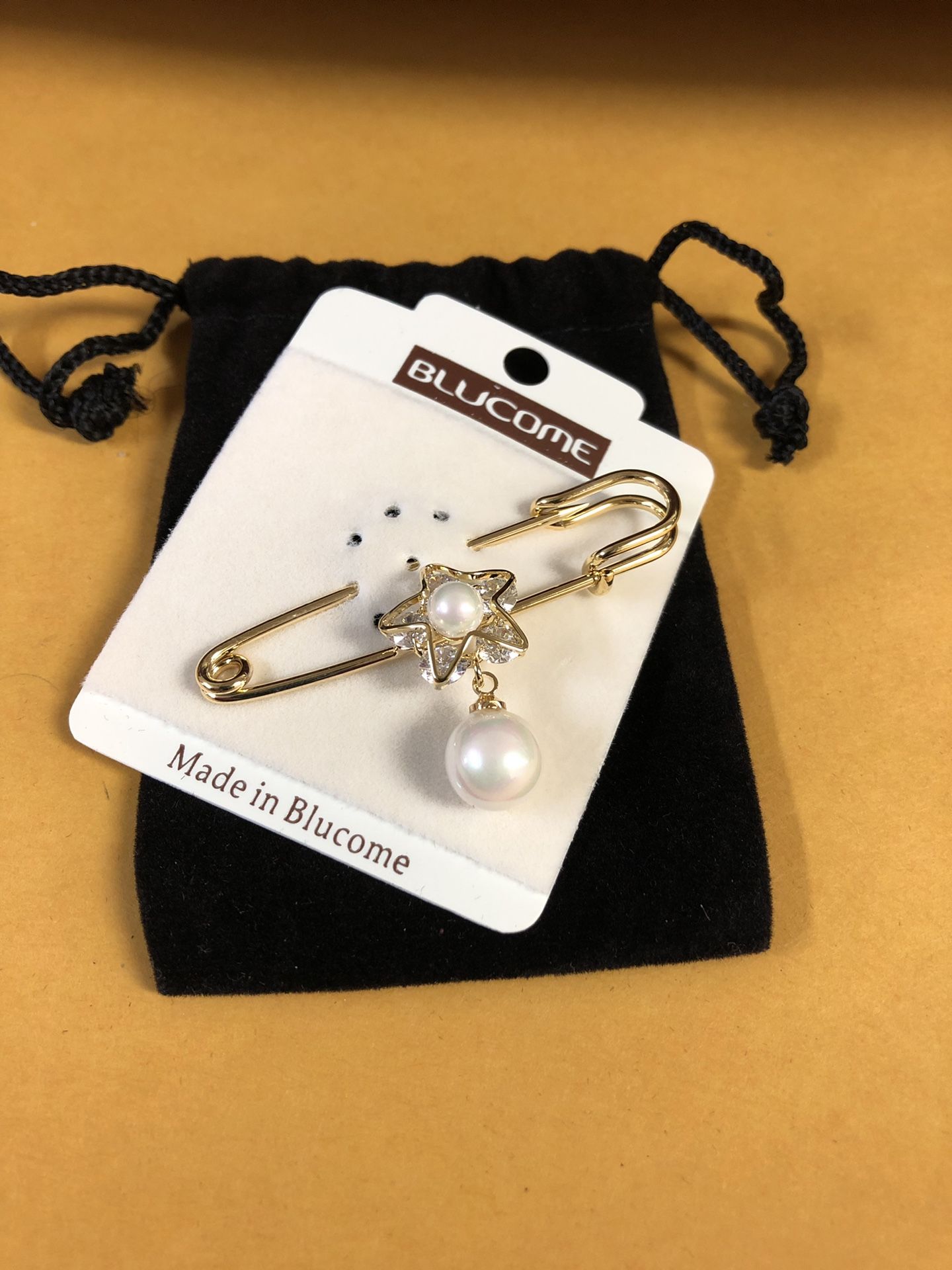 Gold safety pin style brooch