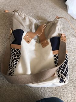 Drawstring canvas bag. Has short strap and shoulder strap made by ugg