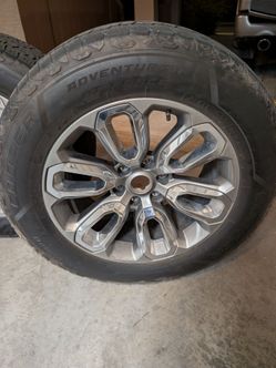 Ram 1500 Laramie rims and tires.