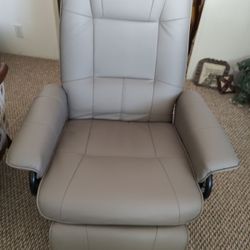 Two near new grey, faux leather swivel recliners