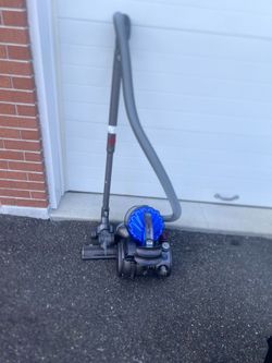 Dyson DC23 Turbinehead Canister Vacuum Cleaner Gray/Blue.  Missing Wheel Works. Used in good condition with some cosmetic  blemishes. These blemishes 