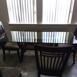 Glass table with five chairs
