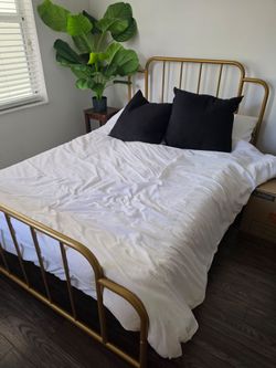 Full size bed with mattress and bedding