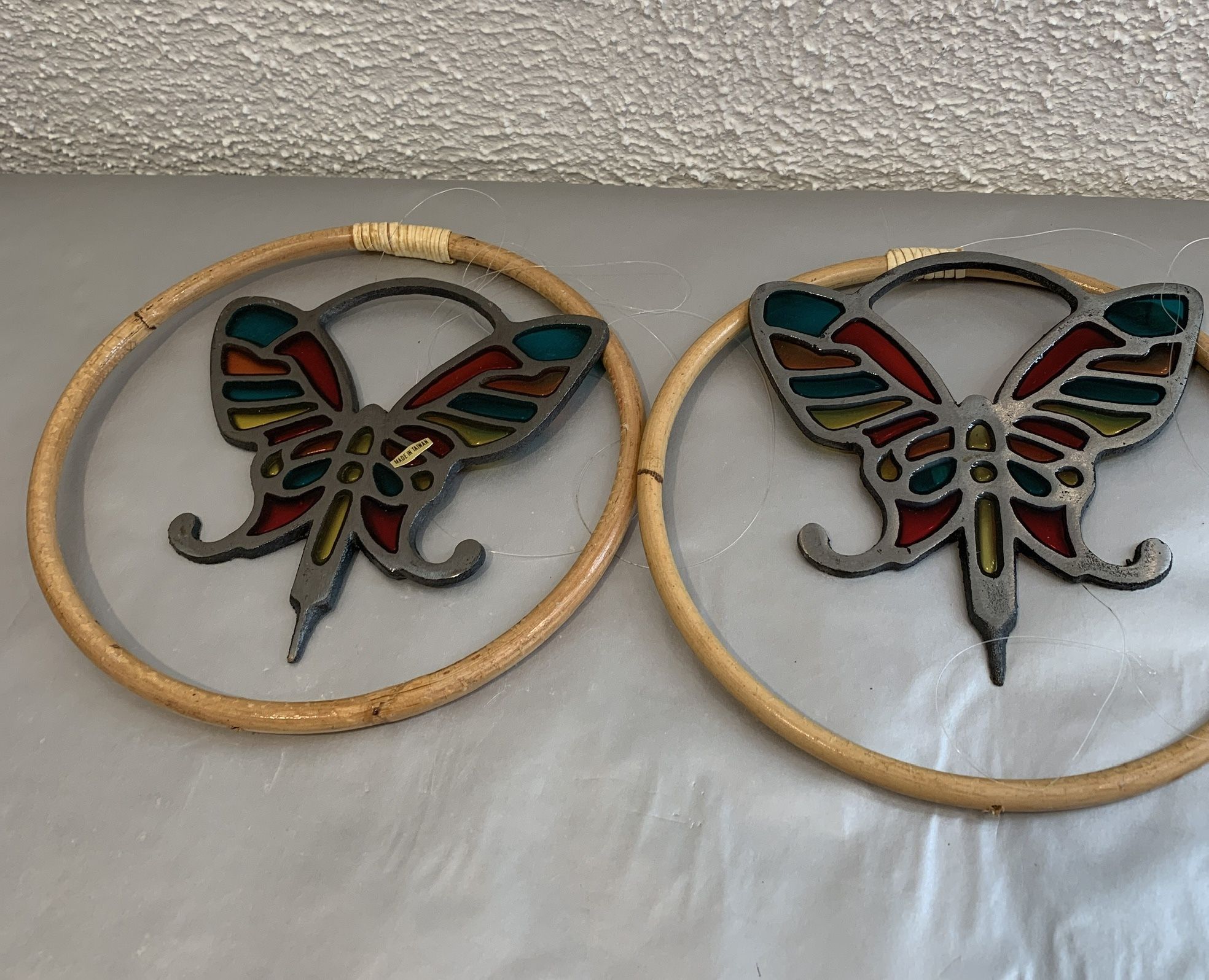 A pair 2 cast iron stained glass butterfly with ring , the ring diameter is 5.50” 1980 stained art glass deco shape , these are vintage Never used .