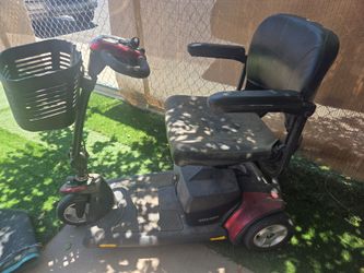 Pride Mobility Go-Go Elite Traveller 3-wheel scooter with a black mesh basket on the front.