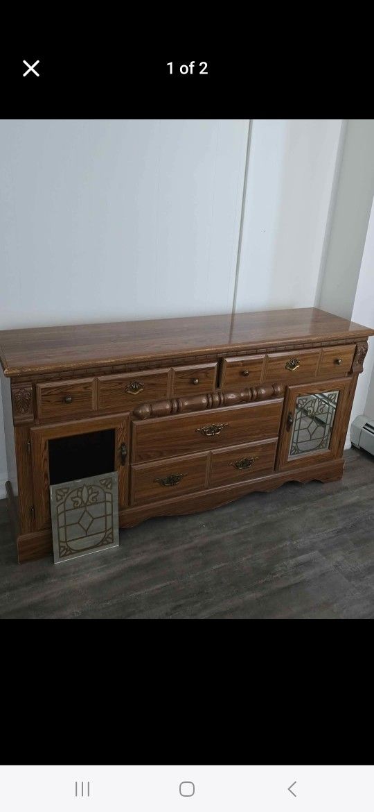 Brown wooden dresser lights up mirror