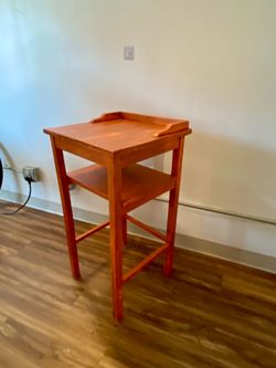 Orange, antique-finished side table w/shelf