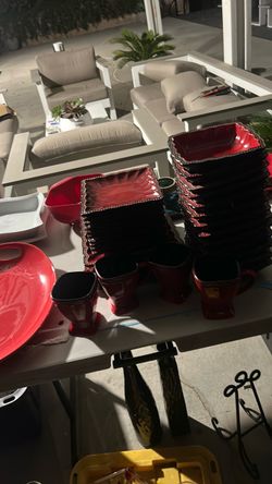 Red dinner set with mugs wine glasses utensils shot glasses
