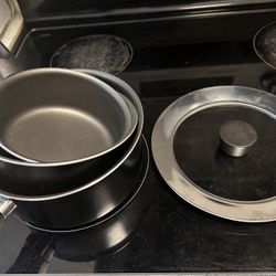 3 saucepans and a lid