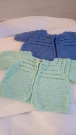 Baby girls sweaters, hand crafted, new, made with soft acrylic yarns, fit 18 to 24 months, $10.00.