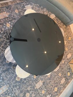 Beautiful black coffee table with 6 marble pieces support.
