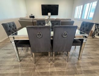 6 gray chairs with glass table