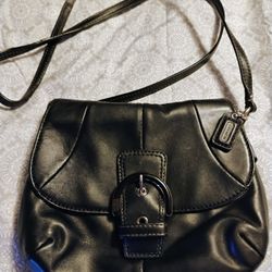 Vintage Coach black leather Soho flap crossbody bag.