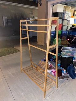 brown wooden bamboo clothing rack