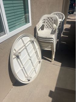 Plastic round table and 13 chairs. White.