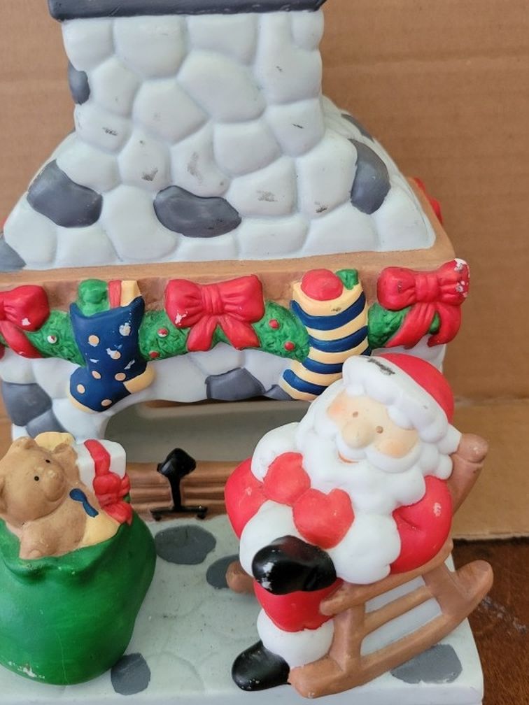 PARTYLITE Christmas Santa Claus figurine Christmas sculpture. Santa by fireplace with present.