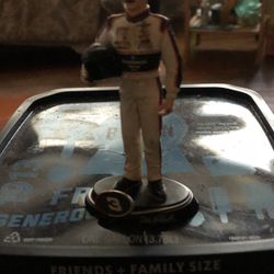 Adele Earnhardt racing uniform with his racing helmet standing on a platform how many in the left-handHelmet