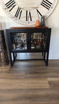 Black console table with mirror inside and under. Crate and barrel