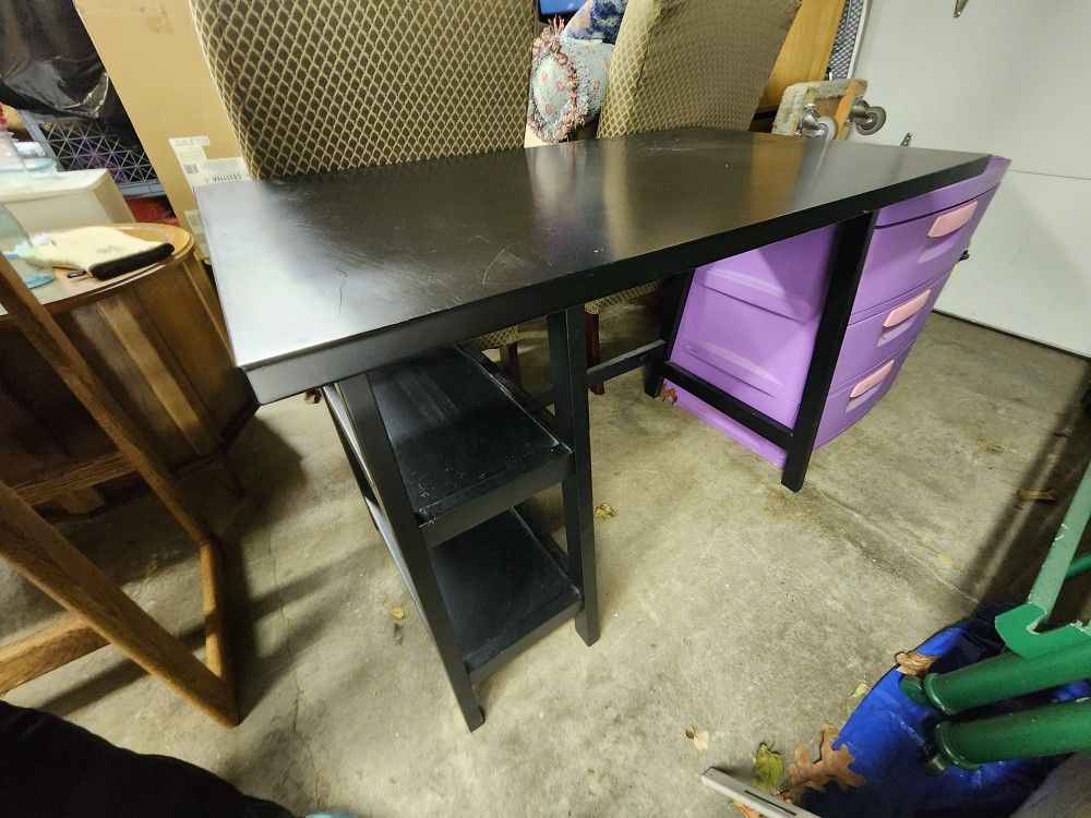 Simple black desk with two shelves.
42"w x 24"d x 30"h 