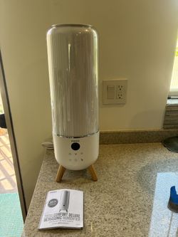 HoMedics TotalComfort Deluxe Ultrasonic Humidifier, model number https://offerup.com/redirect/?o=VUhFLUNNVEY5MS5JdA== covers a 1.47-gallon top-fill ta