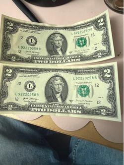 Two dollar bills with unique serial number