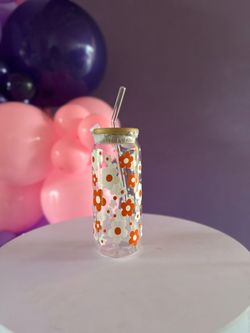 Glass can cup with orange and white flower pattern