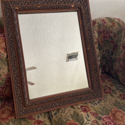 An antique mirror with a frame